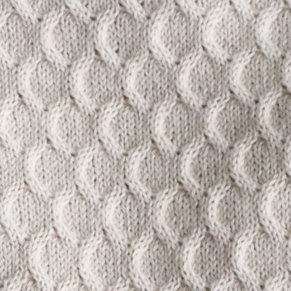 Women's sweater with all over cable pattern and roll edges. Made in Peru by PFL knitwear
