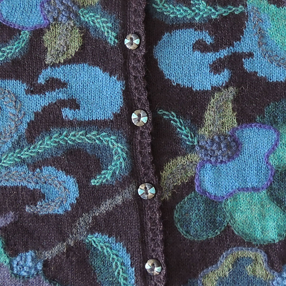 Women's alpaca cardigan Paracas, blue shades, Intarsia knitted with flower pattern. Women's alpaca cardigan Paracas, blue shades, Intarsia knitted with flower pattern.