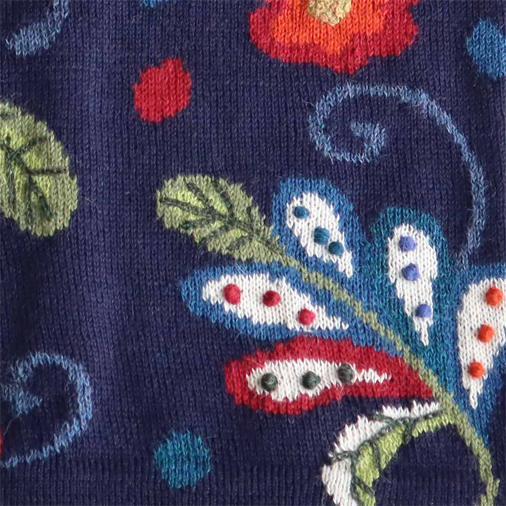 Women's alpaca cardigan model Chivay, intarsia knitted, and hand embroidered details 100% alpaca multi color with flower pattern. MADE IN PERU BY PFL knitwear Women's alpaca cardigan model Chivay, intarsia knitted, and hand embroidered details 100% alpaca multi color with flower pattern. MADE IN PERU BY PFL knitwear