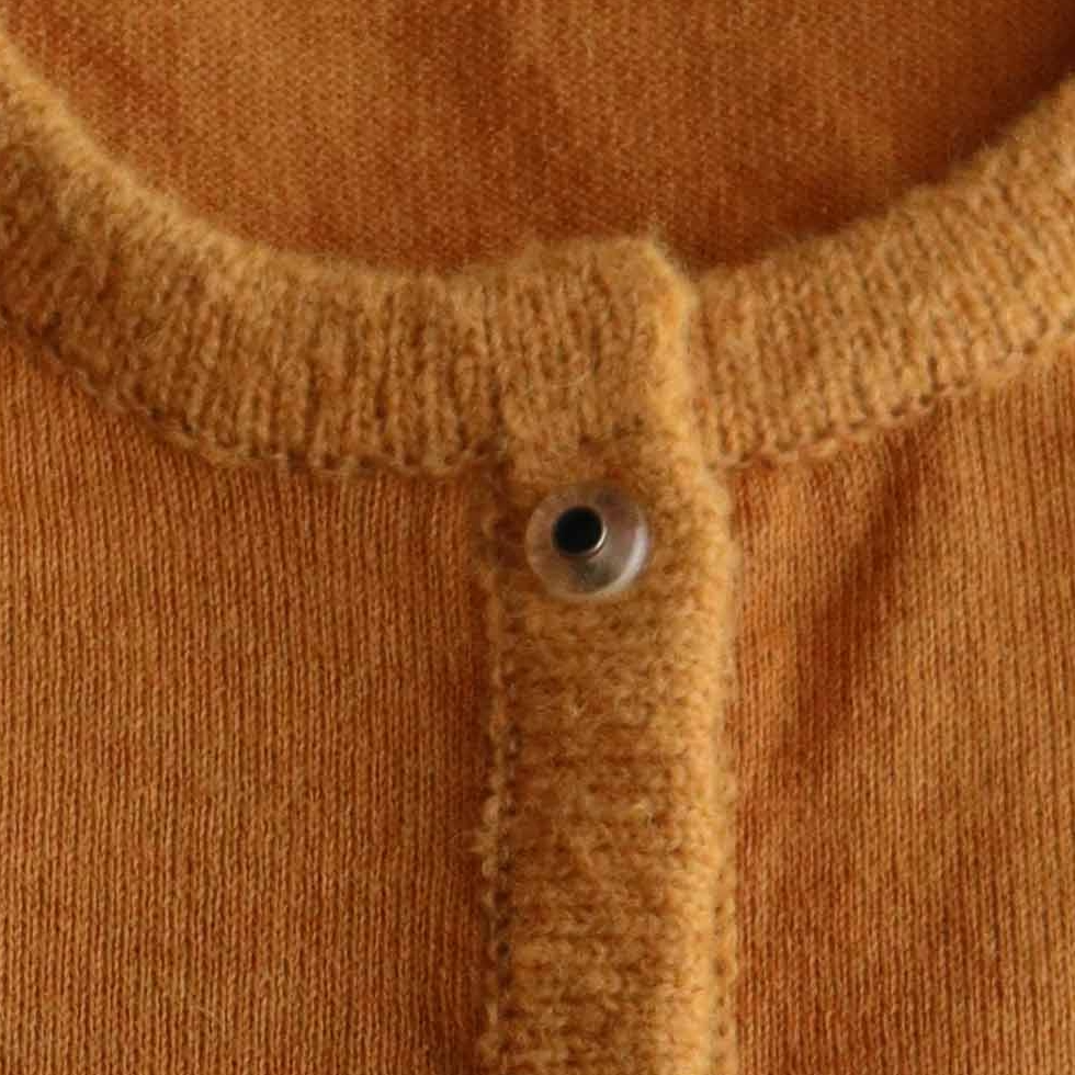 PFL knitwear Cardigan baby alpaca, vest baby alpaca with button closure and crew neck color ginger orange. PFL knitwear Cardigan baby alpaca, vest baby alpaca with button closure and crew neck color ginger orange.